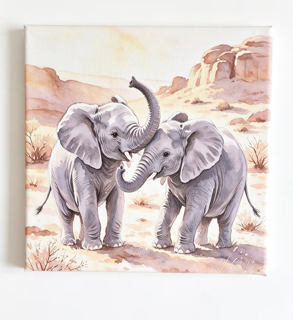 A square watercolor-style art print or canvas showing two gray elephants standing in a desert landscape with tan rocks and sparse shrubs, photographed against a plain white background.