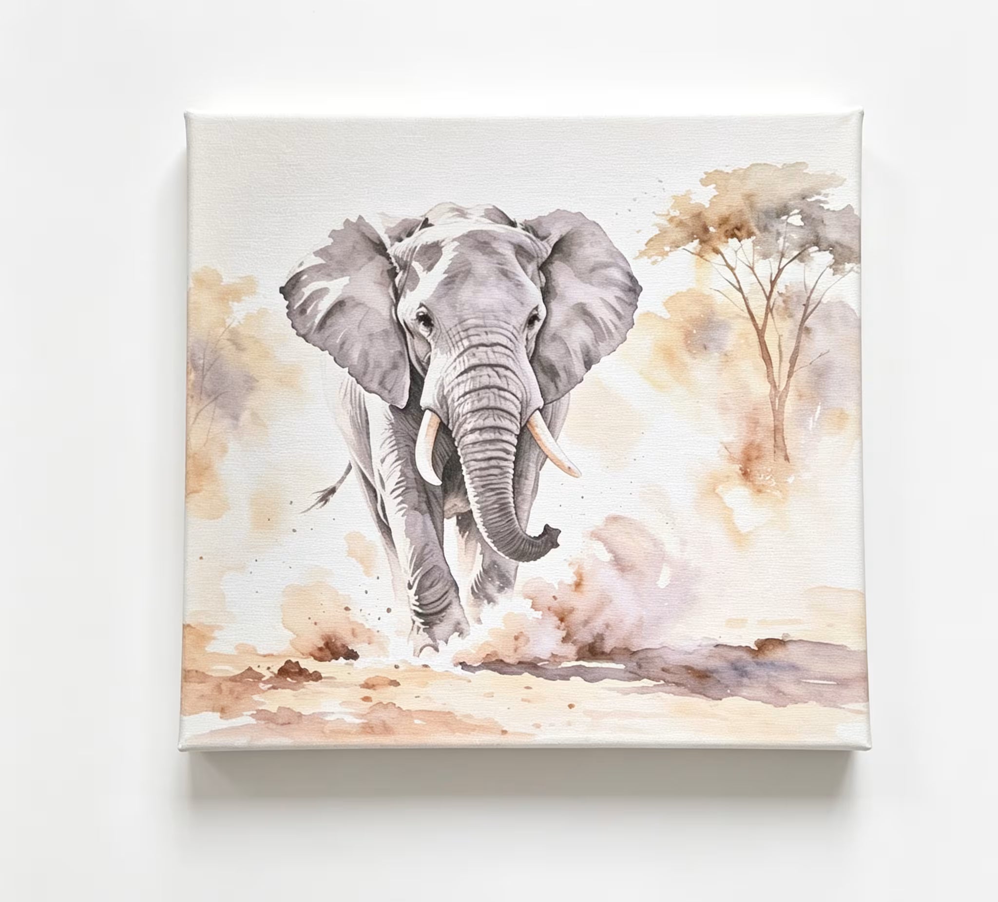 A square canvas wall art print featuring a watercolor-style gray elephant walking forward in a savanna scene with tan trees and dusty ground, shown hanging against a white wall.