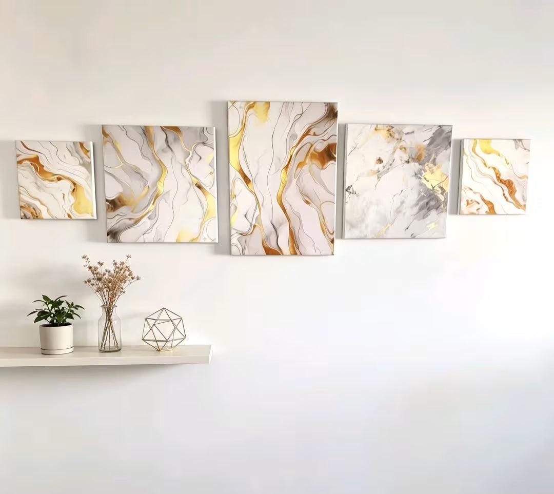 A 5-panel canvas wall art set featuring a modern gold, white, and gray marble design, displayed on a white wall above a shelf with decorative items.
