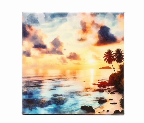 A square canvas wall art print depicting a colorful sunset over an ocean coastline, hanging on a plain white wall.